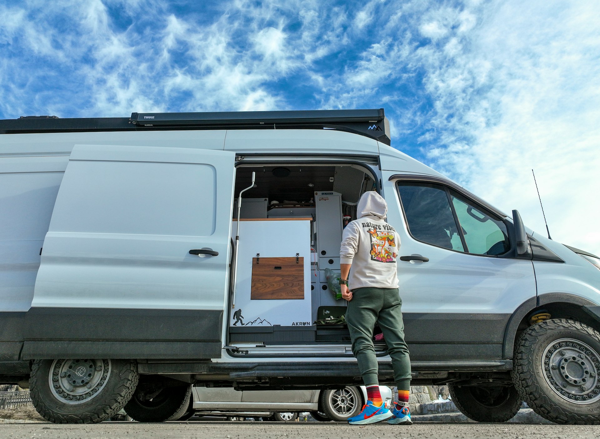 a man standing in the doorway of a van